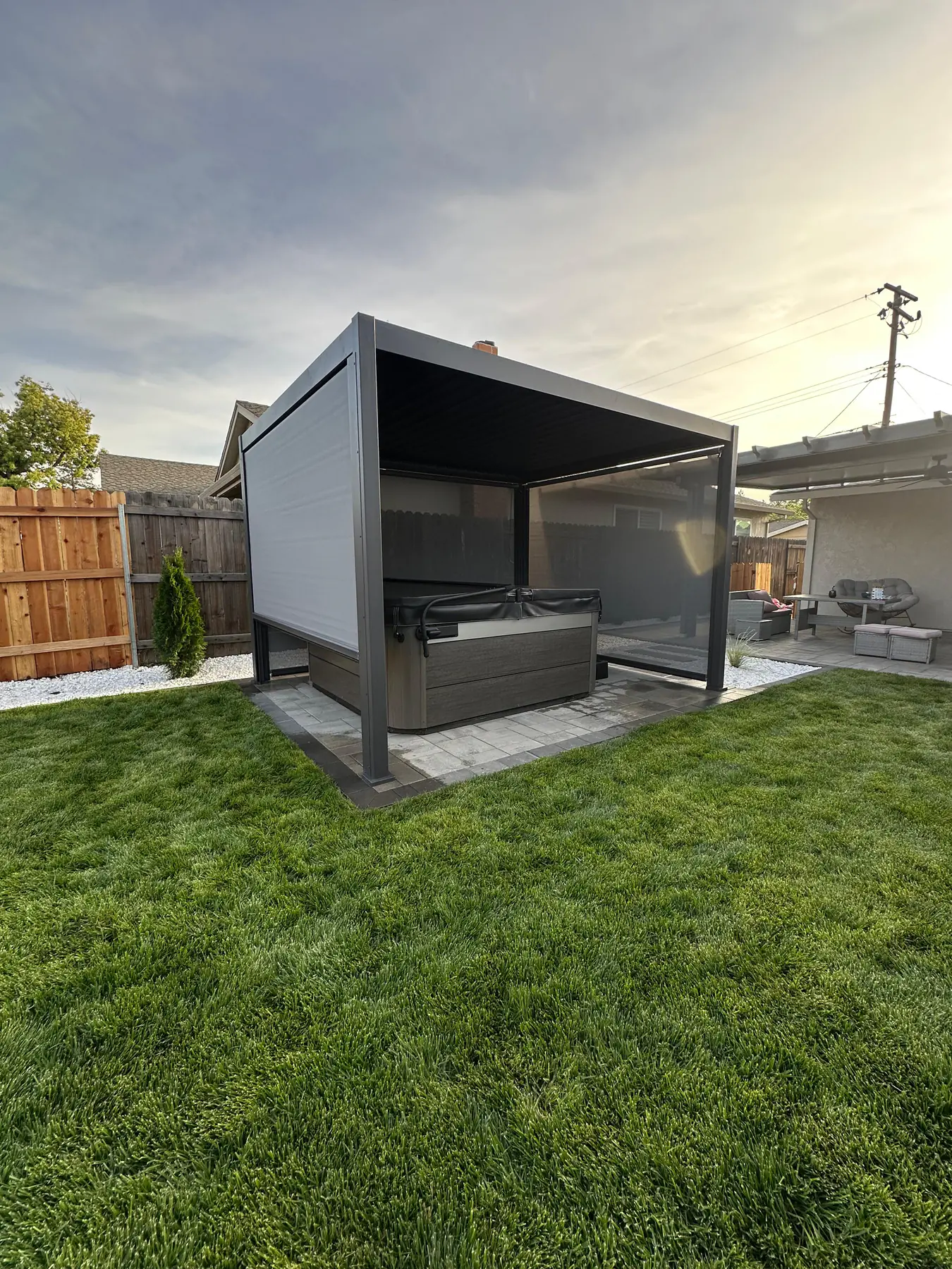 Modern covered outdoor kitchen structure in backyard